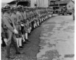 Burma Road dedication parade and ceremony in Kunming, China, on or around February 4, 1945, during WWII. Review of first convoy (or one of the first convoys) to reach China. Chinese soldiers marching in fancy parade dress during, waiting for their turn in the parade.