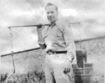 A GI tries out a shoulder pole in China during WWII.