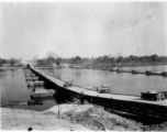 797th Engineer Forestry Company in Burma: Enormous floating bridge over a river on the Burma Road.  During WWII.