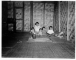 Local people in Burma near the 797th Engineer Forestry Company--A woman with children in a home in Burma.  During WWII.