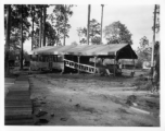 Jungle theater with raised wooden bleachers, covered, with open sides.  797th Engineer Forestry Company in Burma,  During WWII.