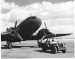 GIs in jeep wait before C-47 transport in China, during WWII. The jeep has a white placard saying "Airdrome Officer."   Although ICD-ATC is stenciled on the jeep, indicating Dum Dum Air Base, the terrain in the background is definitely not that of Dum Dum, and should be China. 