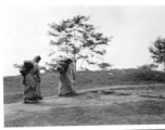 Women carry packs at Darjeeling, India, during WWII.