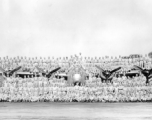 Personnel of the 9th Bombardment Squadron, 7th Bombardment Group, 10th Air Force, pose covering a B-24 bomber during WWII.