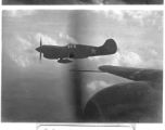 View from B-25s of the 22nd Bombardment Squadron in flight over SW China, Indochina, or Burma during WWII--Happy for the rare escort by P-40s (with external fuel tanks to extend range).