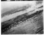 Aerial view of bombing of Tourane, Indochina, by 22nd Bombardment Squadron in the CBI.