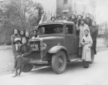 Alice Chong sitting on the bumper of a British truck in Shanghai in February or March of 1938. 