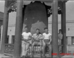 GIs of SACO and a Chinese soldier sit in front of a large cast bell, next to the Lanzhou City Hospital (兰州市立医院) in Gansu province, China, during WWII.