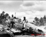 Robert Riese (right) and another GI check out derelict Japanese fighter plane at Liuzhou during WWII, in 1945.