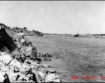 Bob Riese looks over a destroyed bridge at Liuzhou, China, during WWII, in 1945.