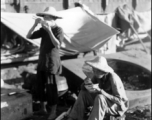 Chinese refugees take a meal at the train station in Liuzhou during WWII, in the fall of 1944.