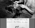 A Chinese mechanic working on a locally cast piston for a jeep.