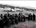 Laborers in China pull a concrete roller at an airbase, with parked P-51 fighters in the background. This was likely in SW China.  From the collection of Hal Geer.