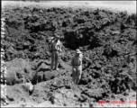American GIs crossing bomb crater on their way to a burning P-40, October 9, 1944.  This is in Guangxi province, either Guilin or Liuzhou.