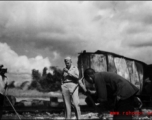 In Liuzhou, Guangxi.  Train in the background burned after Japanese bombing on September 27, 1944.  In the foreground Col. Richard Wise (AGFRTS) takes stock.  According to Hal, Col. Wise was somewhat unconventional, and on at least one occasion made a parachute jump without the proper gear (proper shoes), and was bawled out by Chennault.