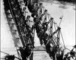 GIs line up to board ship on the way back to the US after the war. The ship is probably the SS Marine Raven.