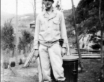 Douglas Runk holding a machete in SW China during WWII.