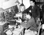 Men work on radio equipment at a base in China.  Image from U. S. Government official sources. 