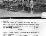 Grenade class in Chinese Infantry non com training school at Dutan, China, observe a man, lower left, in training pit with stick grenade in throwing position.  China. 18 May 1944