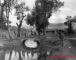 A small bridge near a town wall, with local people  in Yunnan province, China.  From the collection of Eugene T. Wozniak.