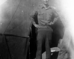 Rex B. Gouger, member of the 76th Fighter Squadron, 23rd Fighter Group, poses in front of a tent in the CBI during WWII.