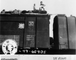 During WWII, photo showing the way refugees live atop freight cars on their way out of Kweilin (Gulin).  Take at the south station, Liuchow, China.