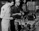 CHINESE AIRMEN GET AMERICAN TRAINING AND EQUIPMENT, 29 January 1944.  Communications is an important phase in the training of the Chinese American Composite Wing (CACW) .  Here, on January 29, 1944, Lt. Kwang Chao-Li checks a defective radio receiver at a test bench in the hanger.  Sgt. Anthony Puflia, Paterson, New Jersey, left, stands by to offer assistance while Sgt. W. L. Whisenant, Chostow, Oklahoma, right, continues with his own duties.  During WWII in China.  Images courtesy of Tony Strotman.