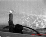 Man uses pole to check water depth in northern China during WWII, probably on the Yellow River.