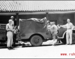 William Butler, Wayne Crusan, Trombley, Derby, Frenchy Beaudetter, Daggett. Outside base office buildings.  Probably at Yangkai.  From the collection of Frank Bates.