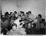 Chaplain Mengel lead his men to participate in outreach to the wartorn and impoverished Chinese countryside. These photos from Chaplain Mengel's private collection, show him with General Chennault, giving out donations from the US airmen.