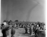 Busy market area with the roof of a temple beyond.  Scenes in India witnessed by American GIs during WWII. For many Americans of that era, with their limited experience traveling, the everyday sights and sounds overseas were new, intriguing, and photo worthy.