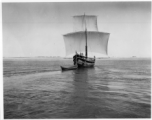 Boat with sails on a river in India.  Scenes in India witnessed by American GIs during WWII. For many Americans of that era, with their limited experience traveling, the everyday sights and sounds overseas were new, intriguing, and photo worthy.